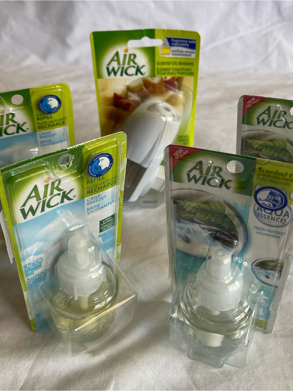 The Air Wick Fresh Waters and Crisp Breeze set includes 4 refills and a warmer,